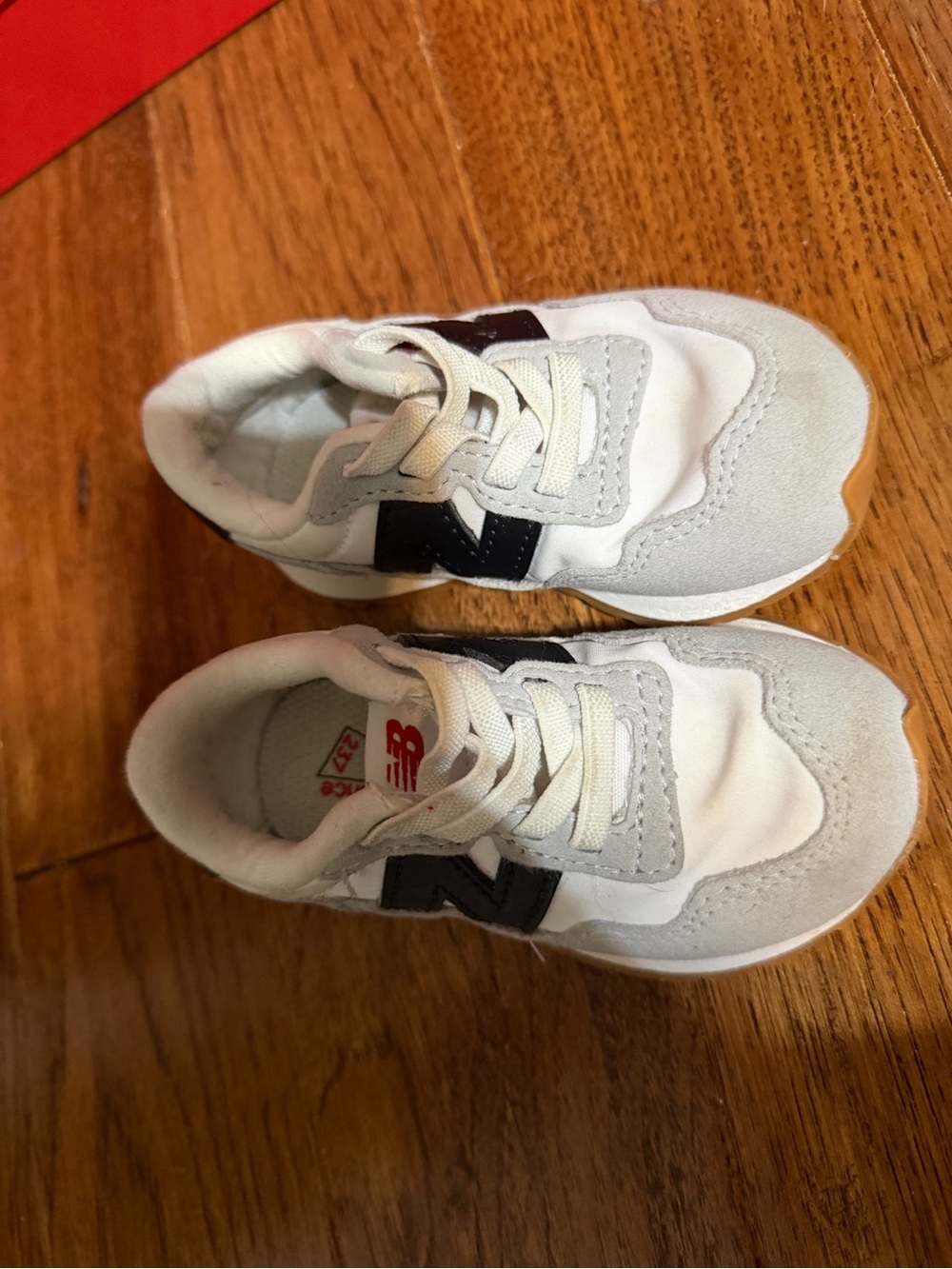 New Balance Kids White and Light Gray Sneakers with Black Logo